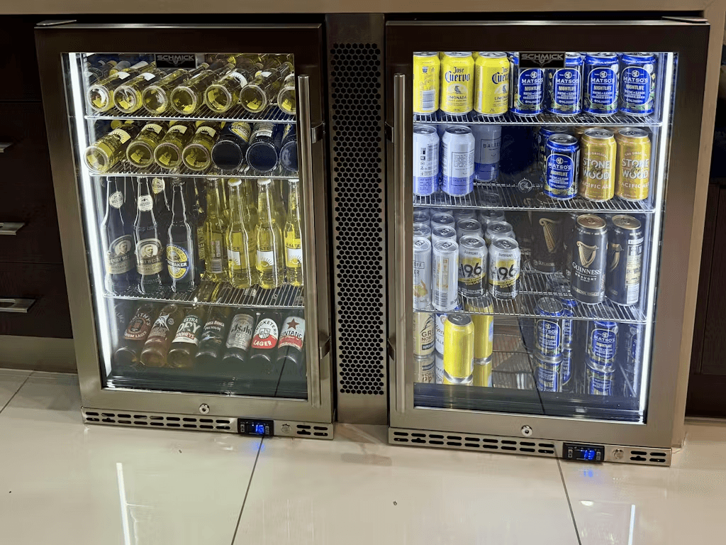 Schmick Stainless Steel Quiet Front Venting Under Bench Heated Glass Door Bar Fridge - Model SK146R-HD styled in home bar setting